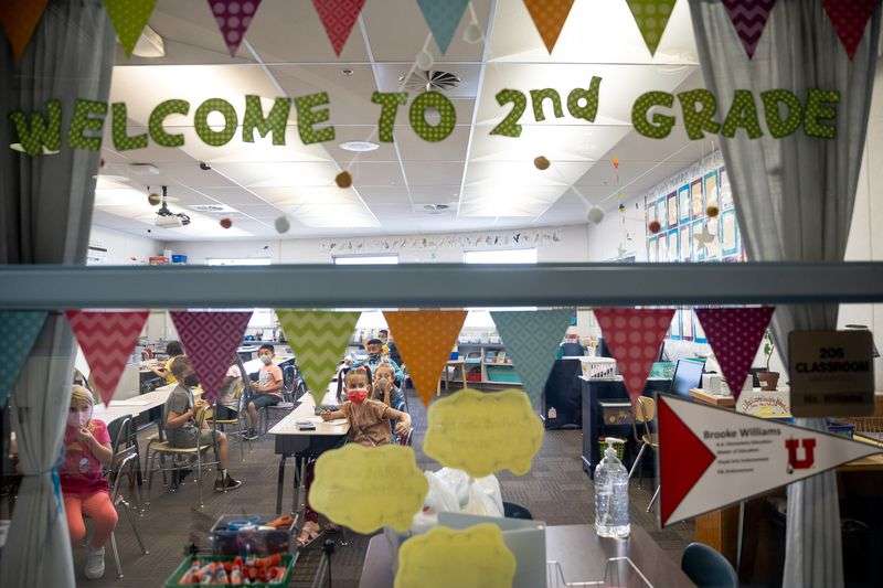 Second grade students are pictured through the window
of their classroom at Nibley Park School in Salt Lake City on
Tuesday, Aug. 24, 2021.