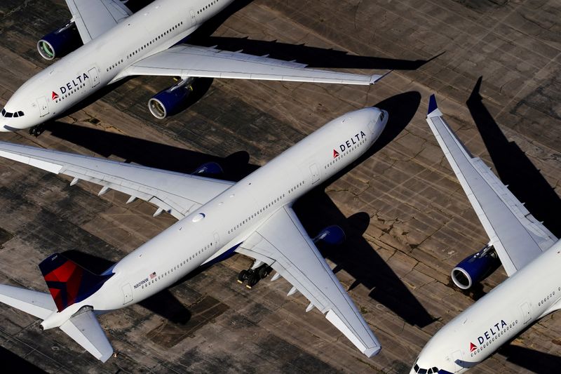 Delta Air Lines planes parked in Birmingham, Alabama. Delta Air Lines on Wednesday said unvaccinated employees will have to pay $200 more every month for their company-sponsored healthcare plan.