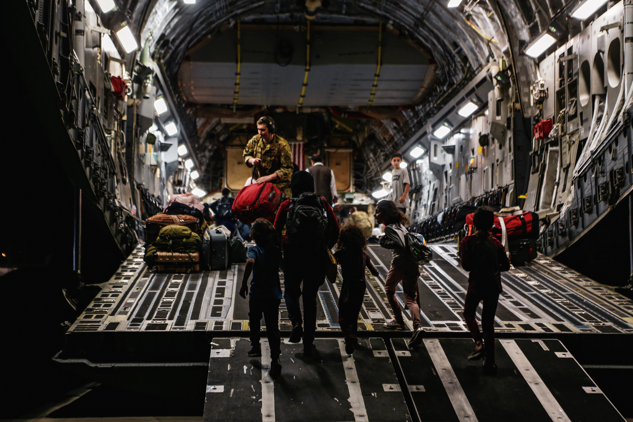 Families board a Boeing C-17 Globemaster III, at Hamid Karzai International Airport, Kabul, Afghanistan, on Monday.
