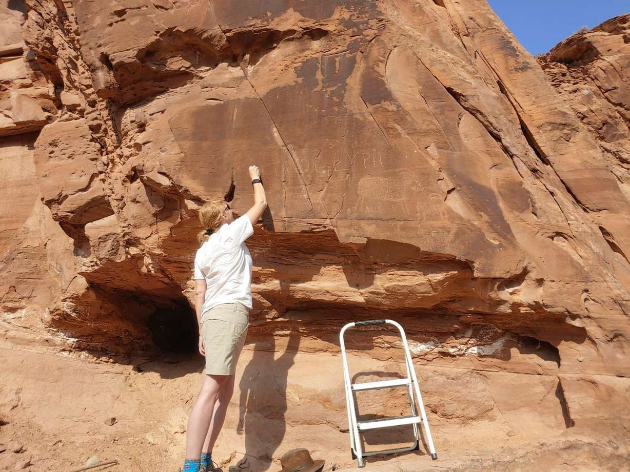 Archaeologists
work to treat a vandalized petroglyph near Moab on Aug. 12. Bureau of Land Management officials said the petroglyph is at least 700 years old.
