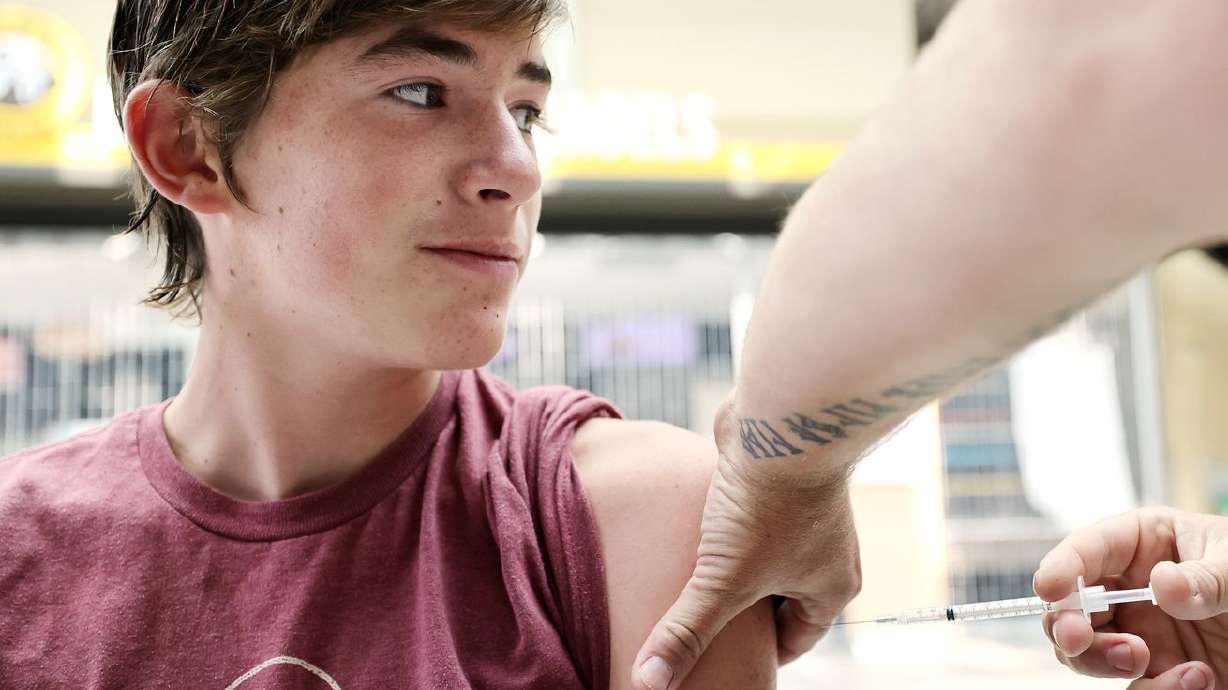 Noah Stapp receives a COVID-19 vaccination at a clinic at Weber State University in Ogden on Aug.
10. The fight against COVID-19 needs to stay focused on getting more vaccinated, not supplying booster shots, University of Utah Health experts said Wednesday.