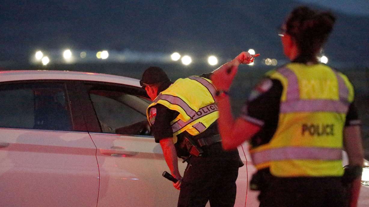 Police officers direct traffic away from a shooting incident on state Route 112 between Grantsville and Tooele on Wednesday.