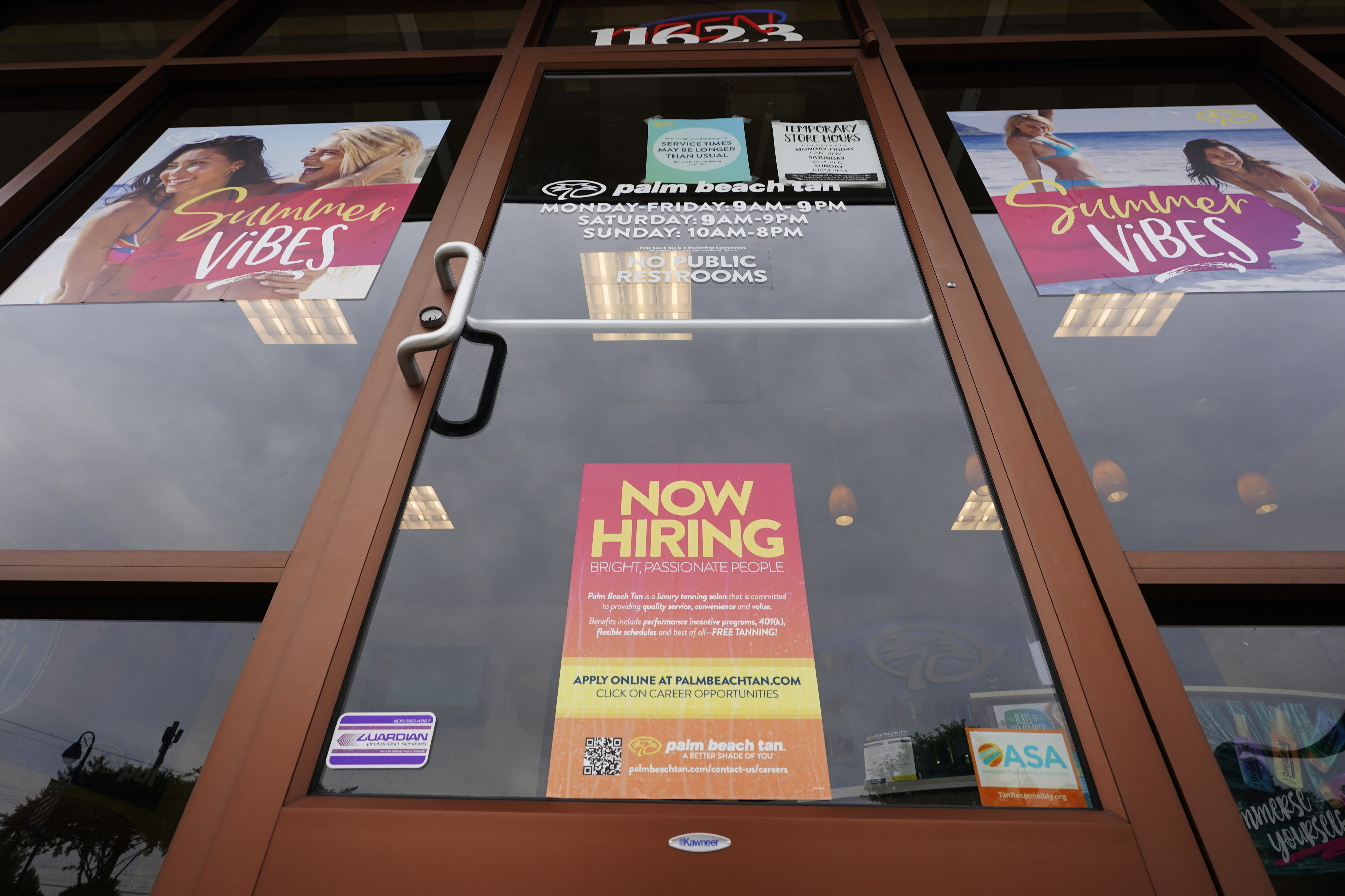 A Now Hiring sign at a business in Richmond, Va., Wednesday, June 2. The number of Americans applying for unemployment benefits rose for the first time in five weeks