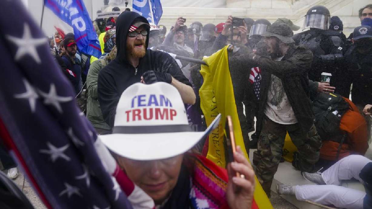 In this Jan. 6, 2021 photo, insurrections loyal to President Donald Trump try to break through a police barrier at the Capitol in Washington. U.S. Capitol Police officers who were attacked and beaten during the Capitol riot filed a lawsuit on Thursday against former President Donald Trump, his allies and members of far-right extremist groups, accusing them of intentionally sending insurrectionists to disrupt the congressional certification of the election in January.