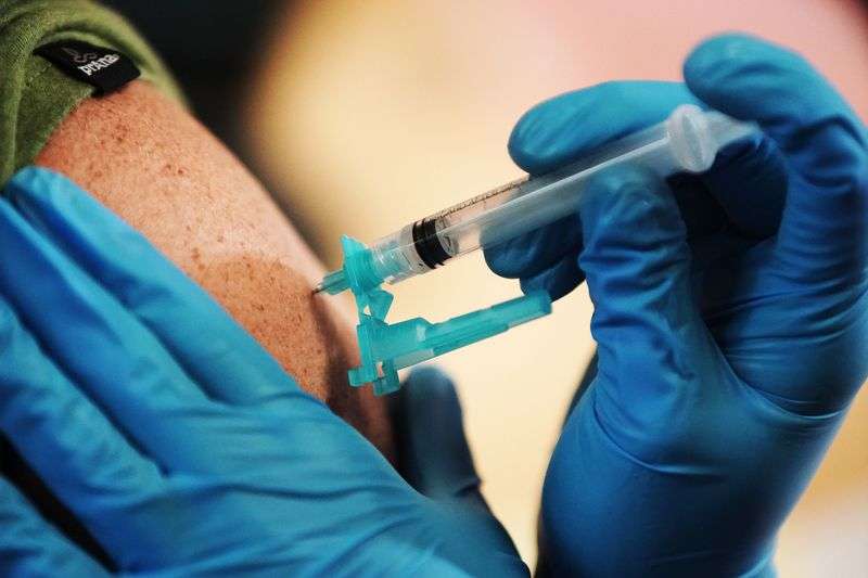 A COVID-19 vaccination is given at Utah Valley
University in Orem on Thursday.