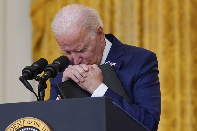 President Joe Biden pauses as he listens to a question
about the bombings at the Kabul airport that killed at least 12
U.S. service members, from the East Room of the White House,
Thursday, in Washington.