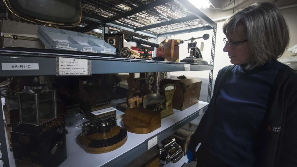 Michele Elnicky, collection specialist for Utah Division of State History, looks at a shelf holding Civilian Conservation Corps equipment, small television tubes donated by television pioneer Philo Farnsworth’s wife and other historic items in 2018. The collection will be moved out of the Rio Grande Depot later this year before the building is retrofitted.