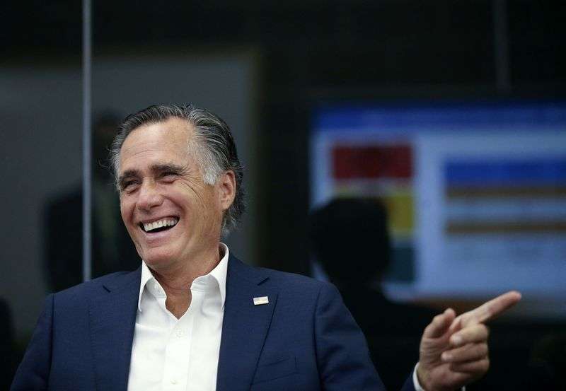 Utah Sen. Mitt Romney teases a staff member about her
speeding while touring the Utah Department of Transportation’s
Traffic Operations Center in Salt Lake City on Thursday.