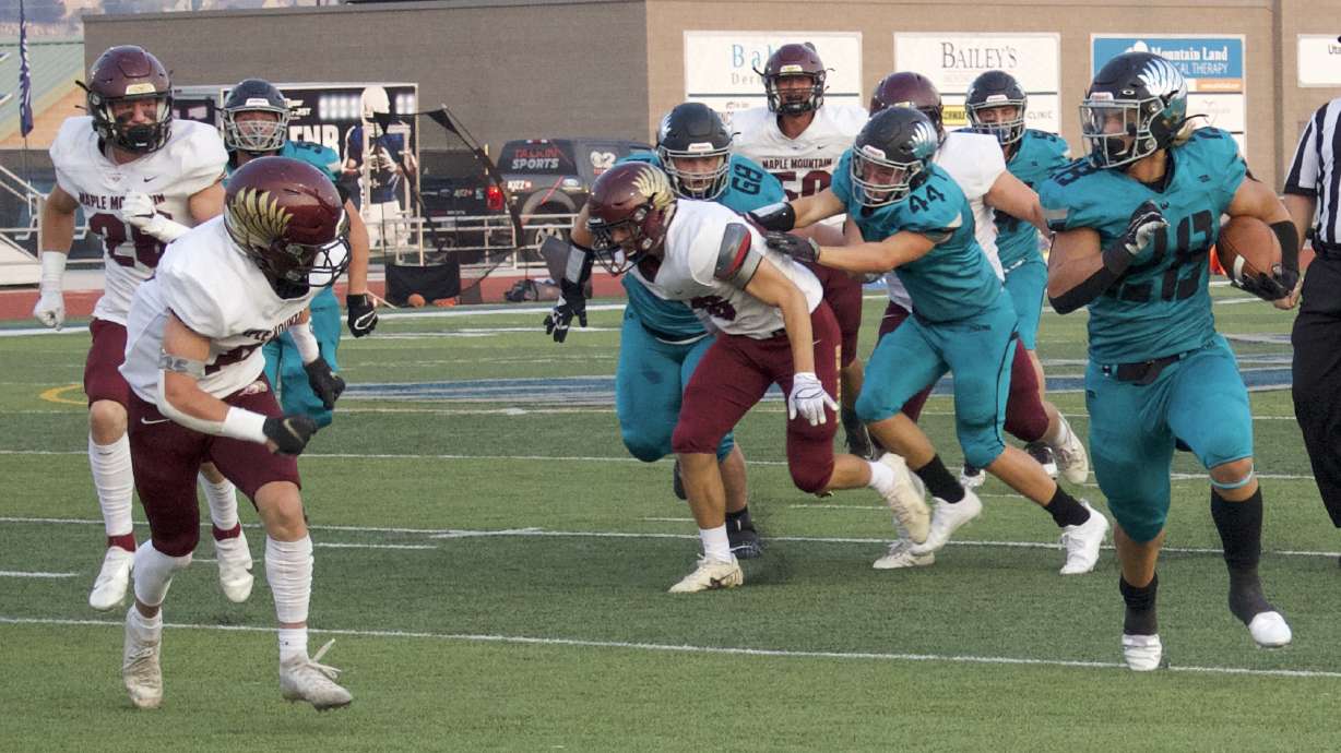 Farmington running back Boston Reinhold runs for yardage during a high school football game at Farmington High School, Thursday, Aug. 26, 2021 in Farmington.