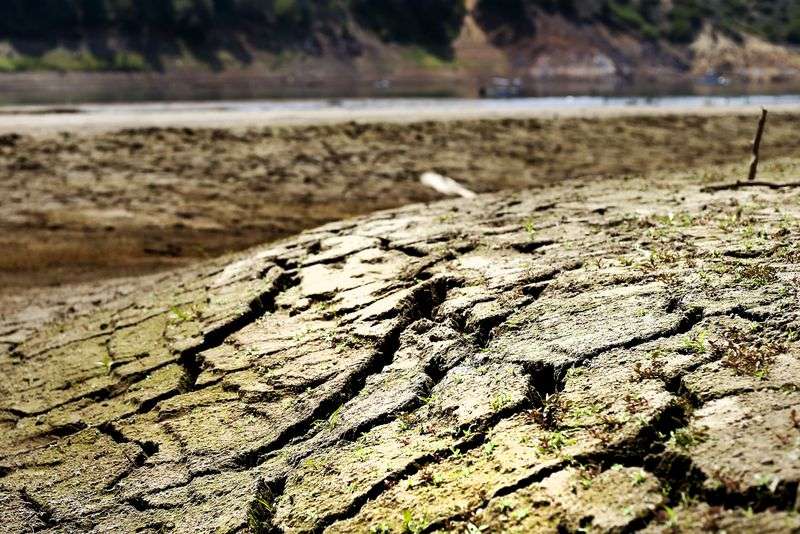 Cracked earth is seen in the waterbed of Jordanelle
Reservoir near Kamas on Aug. 4. Utah’s drought has
forced the closure of the Rock Cliff and Ross Creek boat ramps at
Jordanelle.