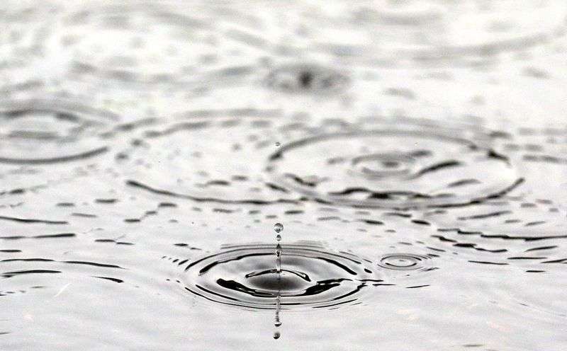 Raindrops fall in a puddle during a rainstorm in Salt Lake City on Aug. 18.