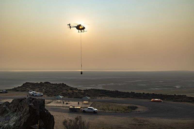 A helicopter flies in to dip water as Utah Division of Wildlife biologists partner with Utah State Parks to fill six of the remote guzzlers at Antelope Island State Park in an effort to provide water to the island’s bighorn sheep on Monday, Aug. 16, 2021. Guzzlers are large devices that catch and store water from snow and rain. They provide drinking water for wildlife and are
especially important during hot, dry summers and drought years.
However, due to the extreme drought this year, some of these guzzlers have run out of water in different areas across the state.