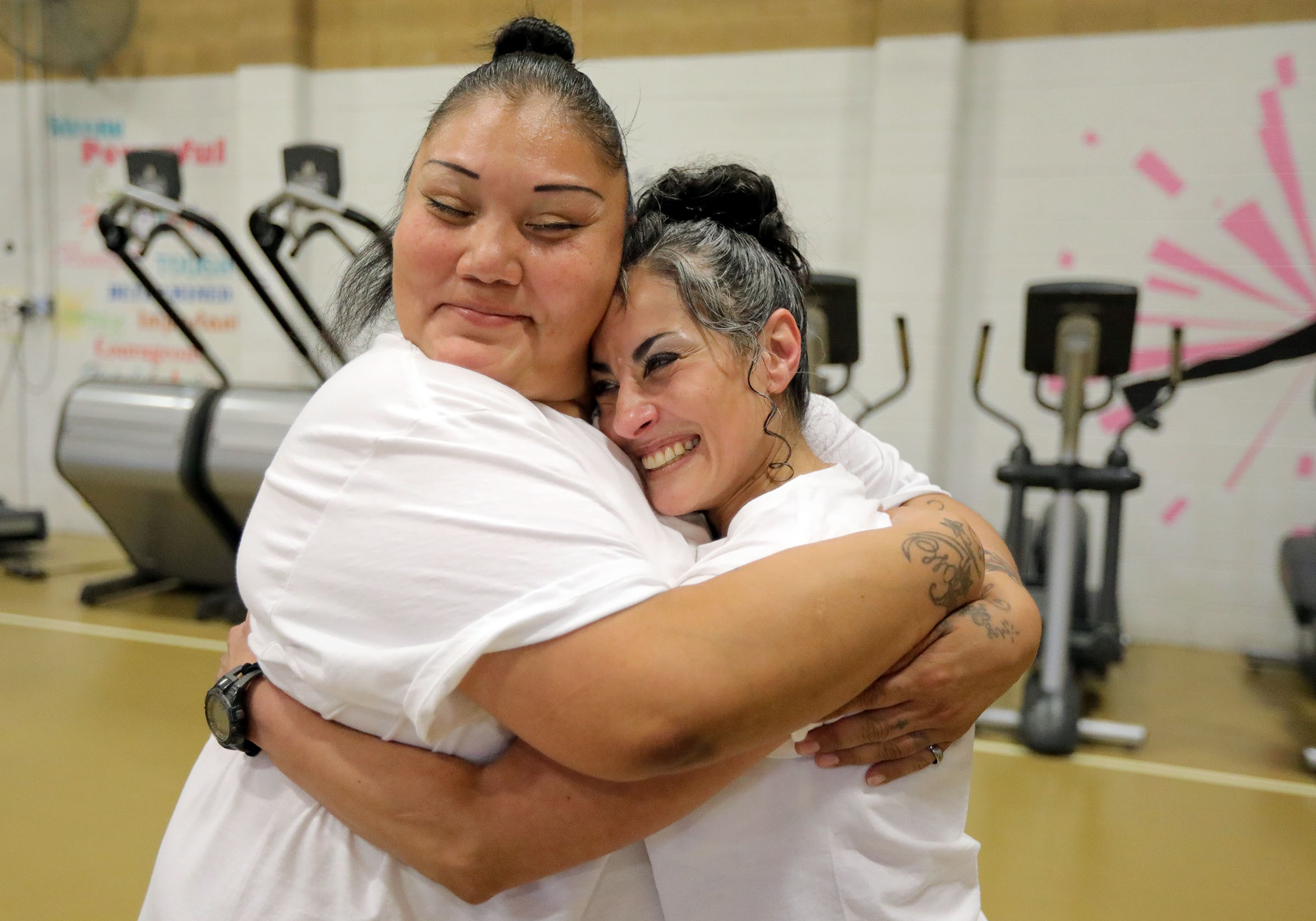 Inmates Crystal Jack Gardner and Fergosa Bluff hug after Bluff taught a yoga class at the Utah State Prison in Draper on Wednesday, Aug. 25, 2021. Bluff is the first inmate to complete 500 hours of yoga teacher training in prison.