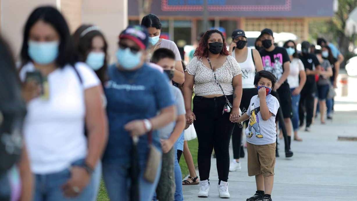 People wait in line for a coronavirus disease test at a back-to-school clinic in South Gate, Los Angeles, California, on Aug. 12. U.S. companies are scrambling to boost production of coronavirus tests increasingly in short supply as COVID-19 cases soar.