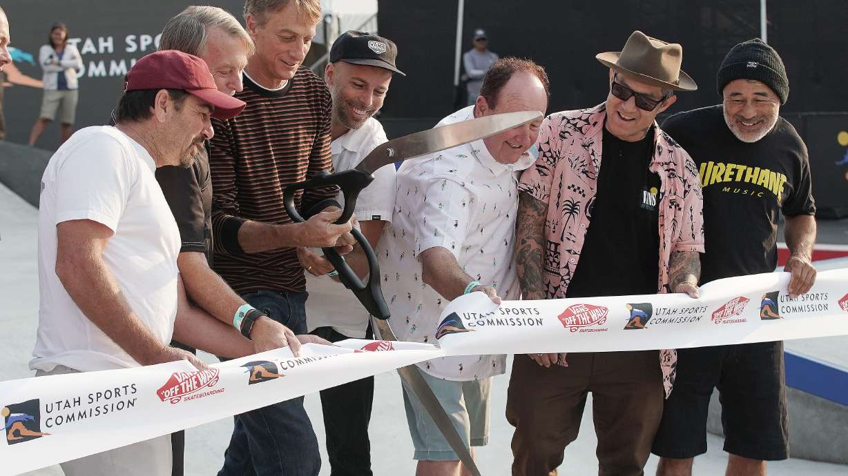 Tony Hawk and others try to cut a ribbon with broken scissors as he hosts Vert Alert skate event at the Utah State Fairpark in Salt Lake City on Friday. Hawk responded to social media accusations that he copied an idea from rapper Lil Nas X to use blood in his skateboard paint.