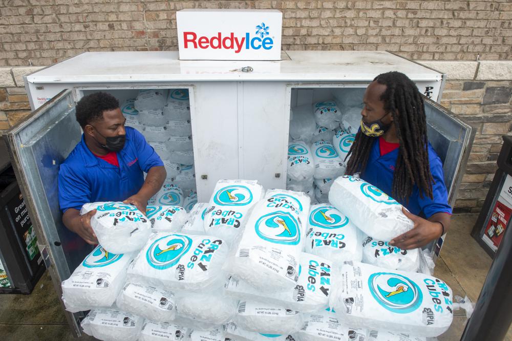 Corey Williams, right, and John Smith, both of Pelican Ice, hurriedly stack bags of ice into a gas station freezer in preparation for Tropical Storm Ida on Friday in Jefferson, La. Forecasters now say Ida could be a major Category 3 hurricane with top winds of 115 mph when it nears the U.S. coast.