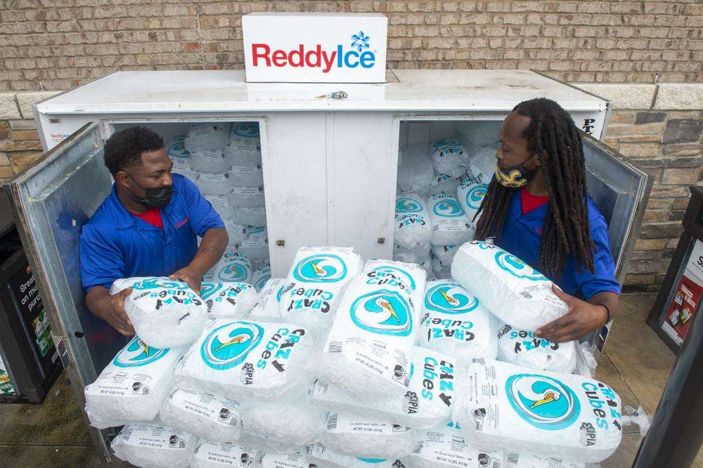 Corey Williams, right, and John Smith, both of Pelican Ice, hurriedly stack bags of ice into a gas station freezer in preparation for Tropical Storm Ida on Friday in Jefferson, La. Forecasters now say Ida could be a major Category 3 hurricane with top winds of 115 mph when it nears the U.S. coast.