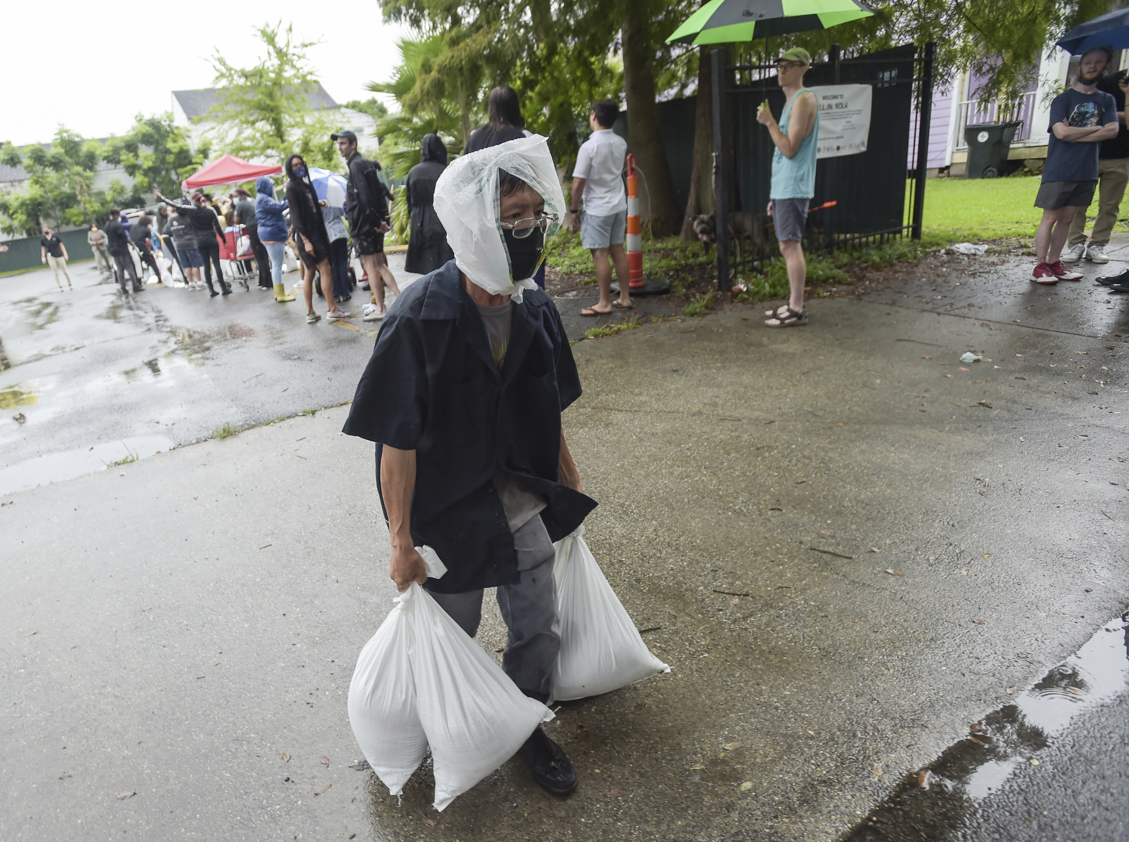 A resident takes home sandbags from a city run sandbag distribution location at the Dryades YMCA on Aug. 27 in New Orleans, as residents prepare for Hurricane Ida.
