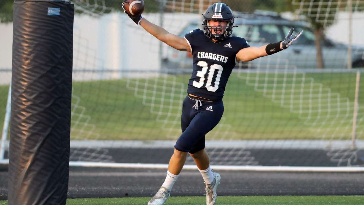 Corner Canyon's Dylan Carlsen celebrates a touchdown during a high school football game against Bingham at Corner Canyon High School, Aug. 27, 2021. Carlsen scored his fourth touchdown of the season in the Chargers' 52-7 win over Lehi to wrap up non-region play with a 46-game winning streak.