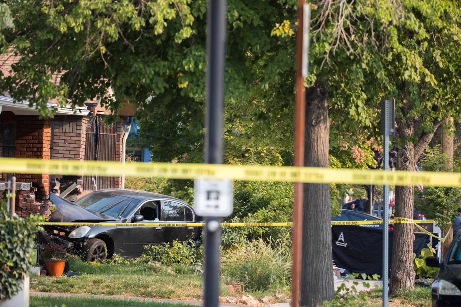 Police investigate the scene where an 18-year-old was shot and killed in a car after running away from a house party in Salt Lake City on Aug. 29, 2021.