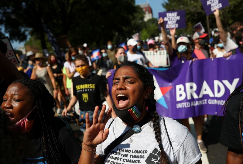 A demonstrator shouts slogans at an anti-voter suppression laws march near the White House, Washington, Saturday.