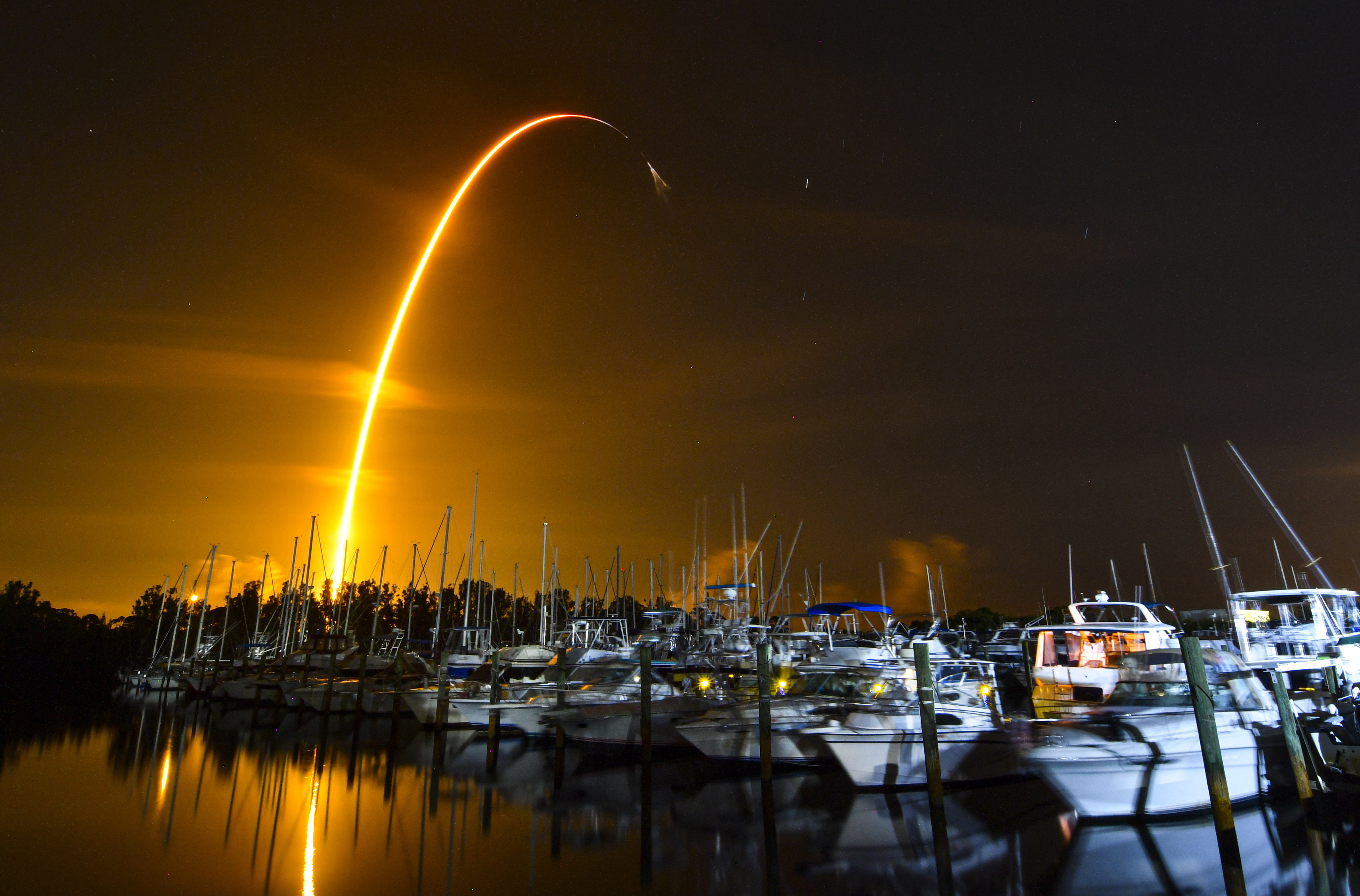 This long exposure photo shows the launch of a SpaceX Falcon 9 rocket on a resupply mission for NASA to the International Space Station from Pad 39A at Kennedy Space Center, seen from Merritt Island, Fla., Sunday.