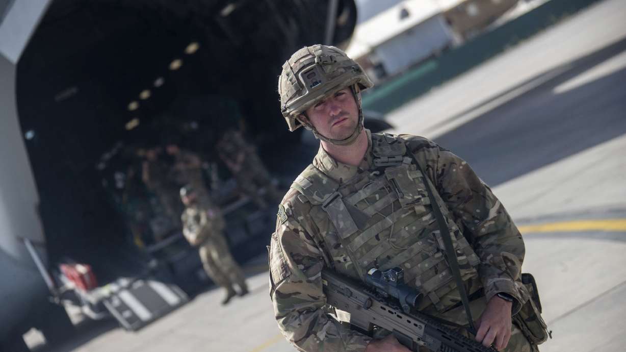 Photo issued on Saturday by Britain's Ministry of Defense showing UK military personnel boarding a A400M aircraft departing Kabul, Afghanistan.