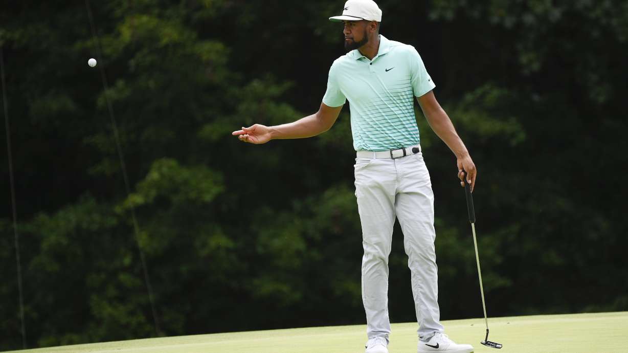 Tony Finau tosses his ball to his caddie on the 7th green during the final round of the BMW Championship golf tournament, Sunday, Aug. 29, 2021, at Caves Valley Golf Club in Owings Mills, Md.