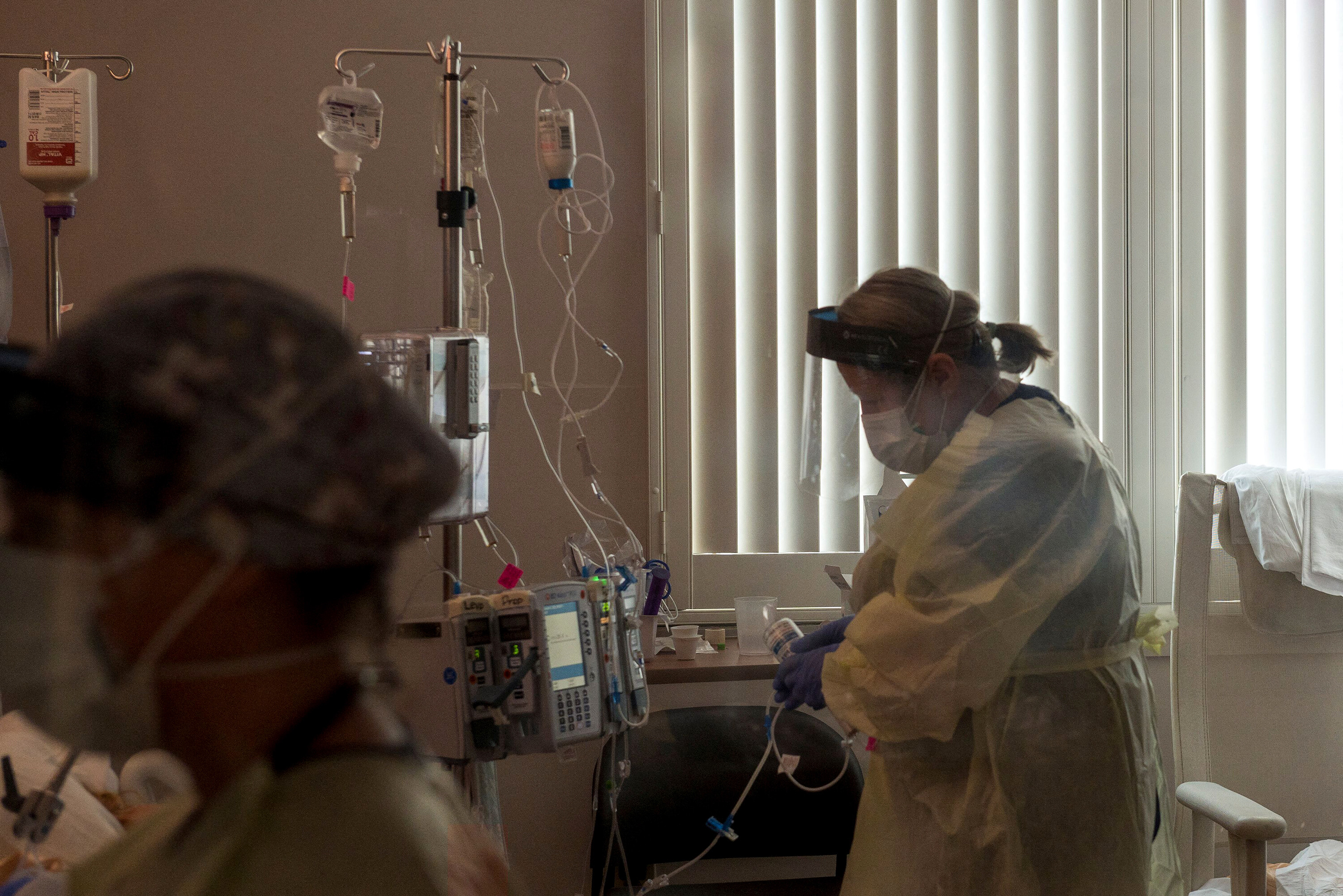 A nurse tends to a COVID-19 patient inside a California ICU.