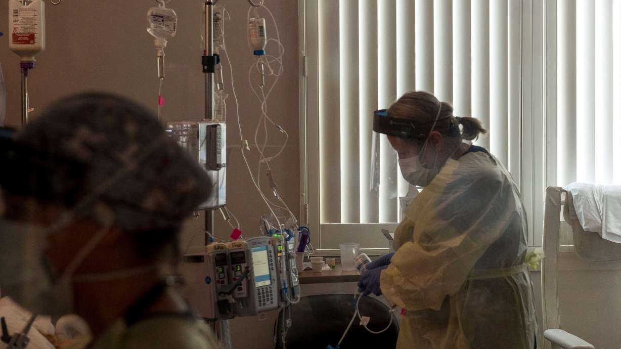 A nurse tends to a COVID-19 patient inside a California ICU.
