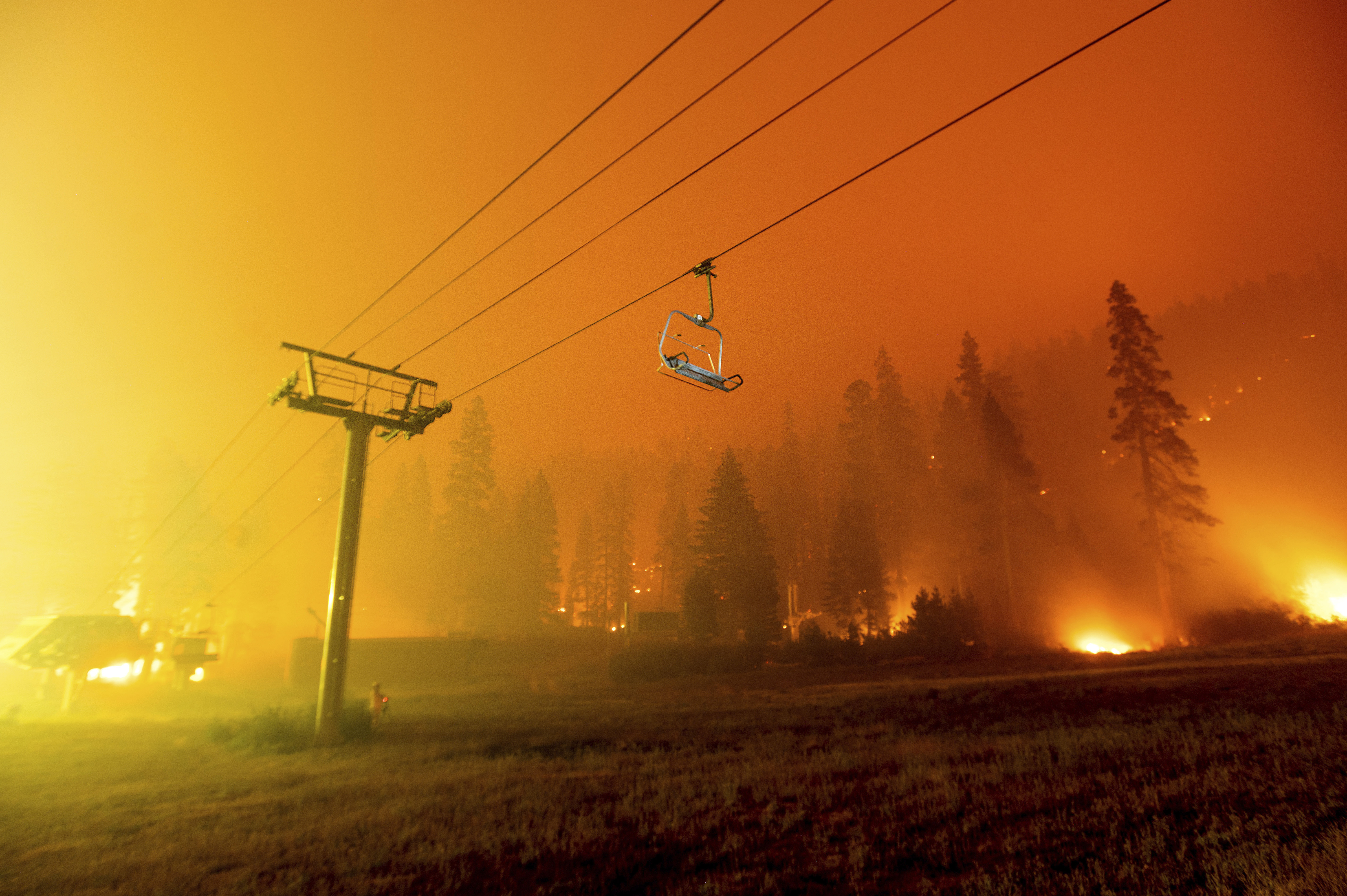 The Caldor Fire burns at the Sierra-at-Tahoe ski resort on Sunday, Aug. 29, 2021, in Eldorado National Forest, Calif. The main buildings at the ski slope's base survived as the main fire front passed.