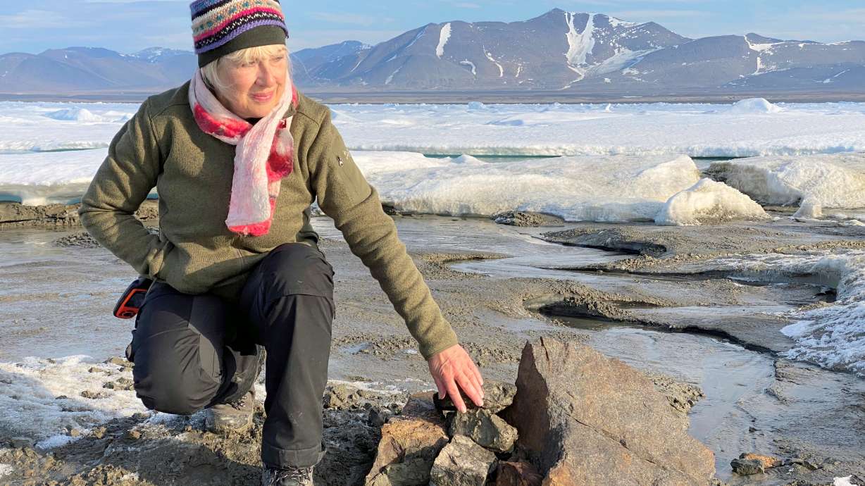 An undated handout image of Swiss entrepreneur Christiane Leister, creator of the Leister Foundation that financed an expedition that discovered a tiny island off the coast of Greenland which they say is the world's northernmost point of land, in front of a cairn in which expedition members left a message with details of their visit.
