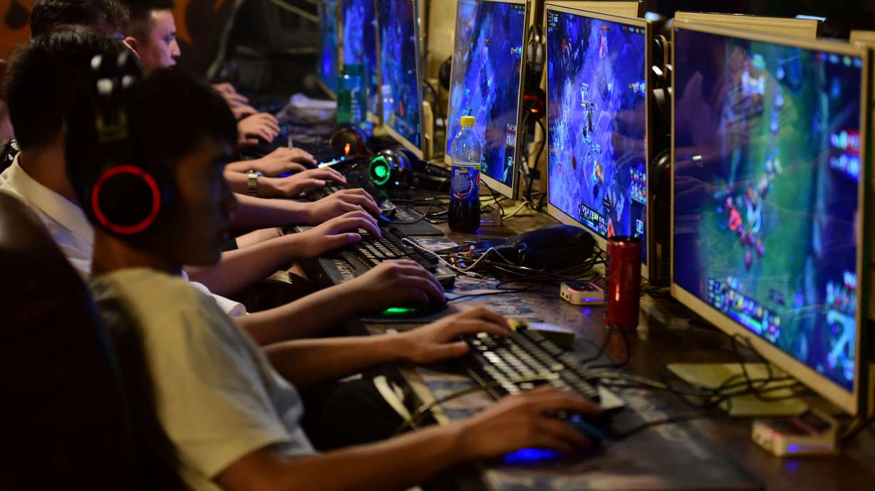 People play online games at an internet cafe in Fuyang, Anhui province, in China in 2018. China has forbidden under-18s from playing video games for more than three hours a week, saying there's growing addiction to what the nation once described as "spiritual opium."