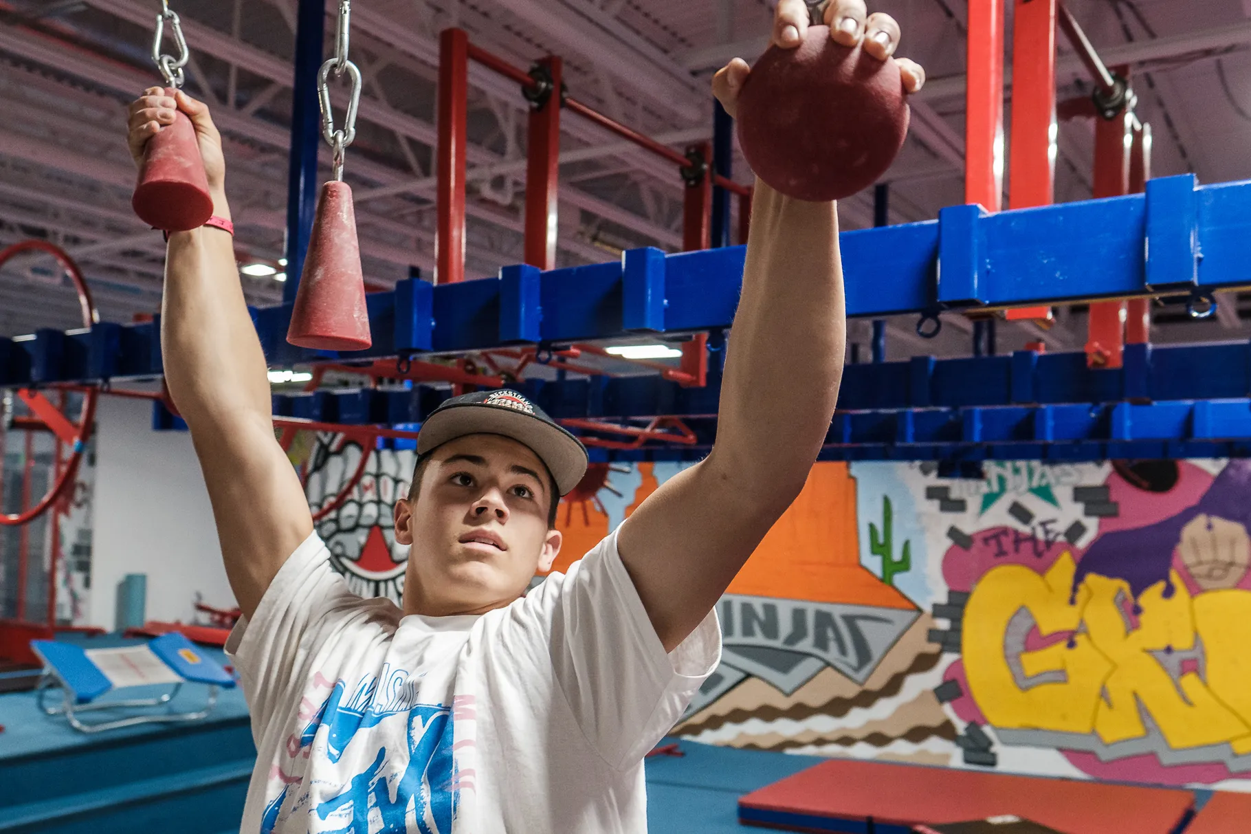 Kai Beckstrand demonstrates parts of his training regimen at his family’s gym in St. George on Saturday, Aug. 28, 2021. Beckstrand’s efforts landed the 15-year-old in the finals of the competition television show "American Ninja Warrior."