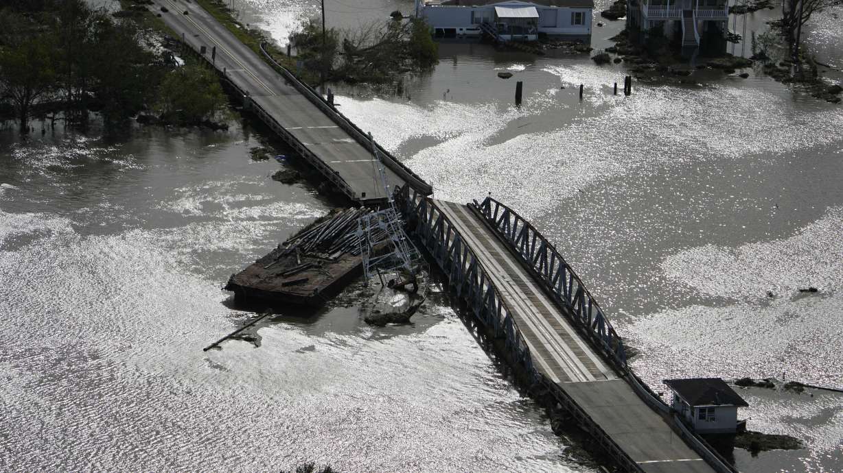 A barge damages a bridge that divides Lafitte, La., and Jean Lafitte, in the aftermath of Hurricane Ida, on Monday in Louisiana.