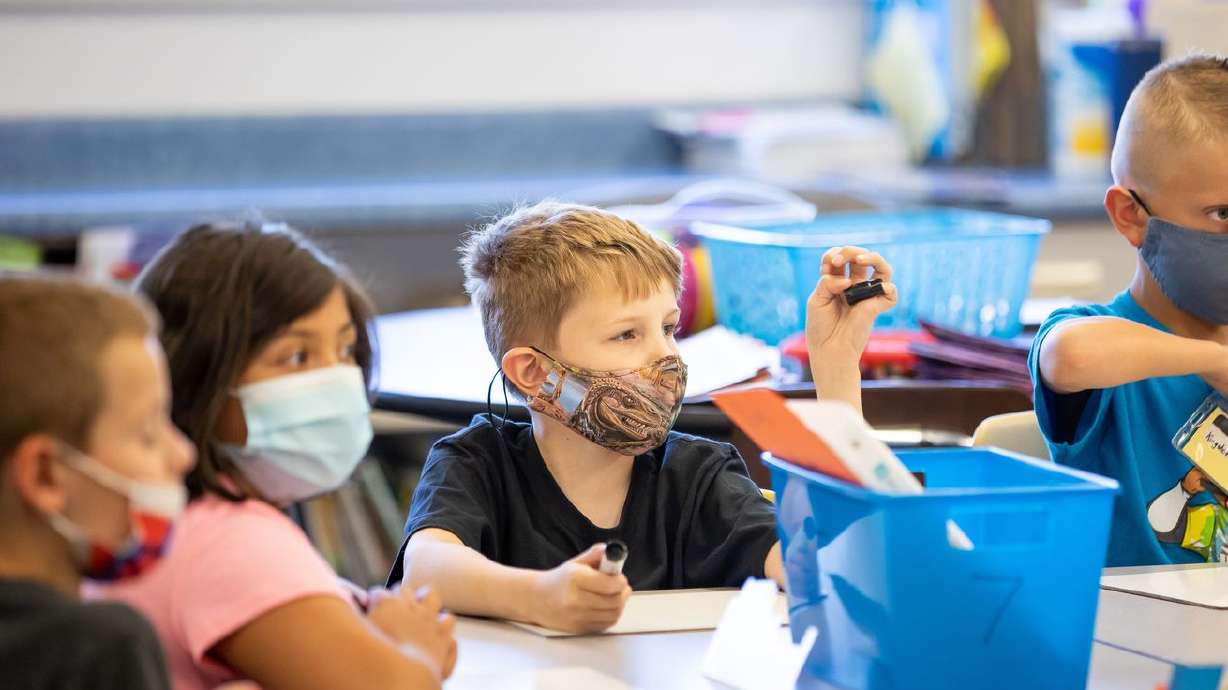 Josh Bird, Leslie Mancilla, Kaiden Smolka and Kingston
Pedokie sit together in their third grade class at Nibley Park
School in Salt Lake City on Aug. 24.