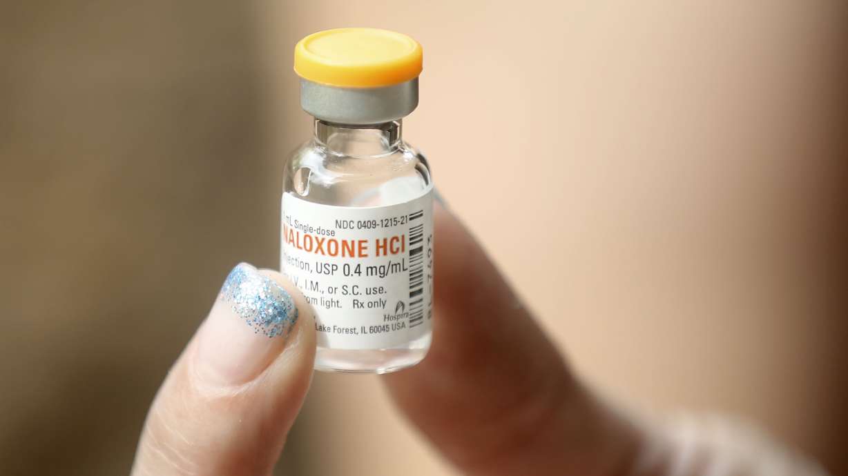 Amy Daeschel shows a dose of naloxone, which is used to reverse an opioid overdose, outside of Steps Recovery Center in Murray on July 22, 2020. Daeschel says she was saved by naloxone and has since saved two others with naloxone.