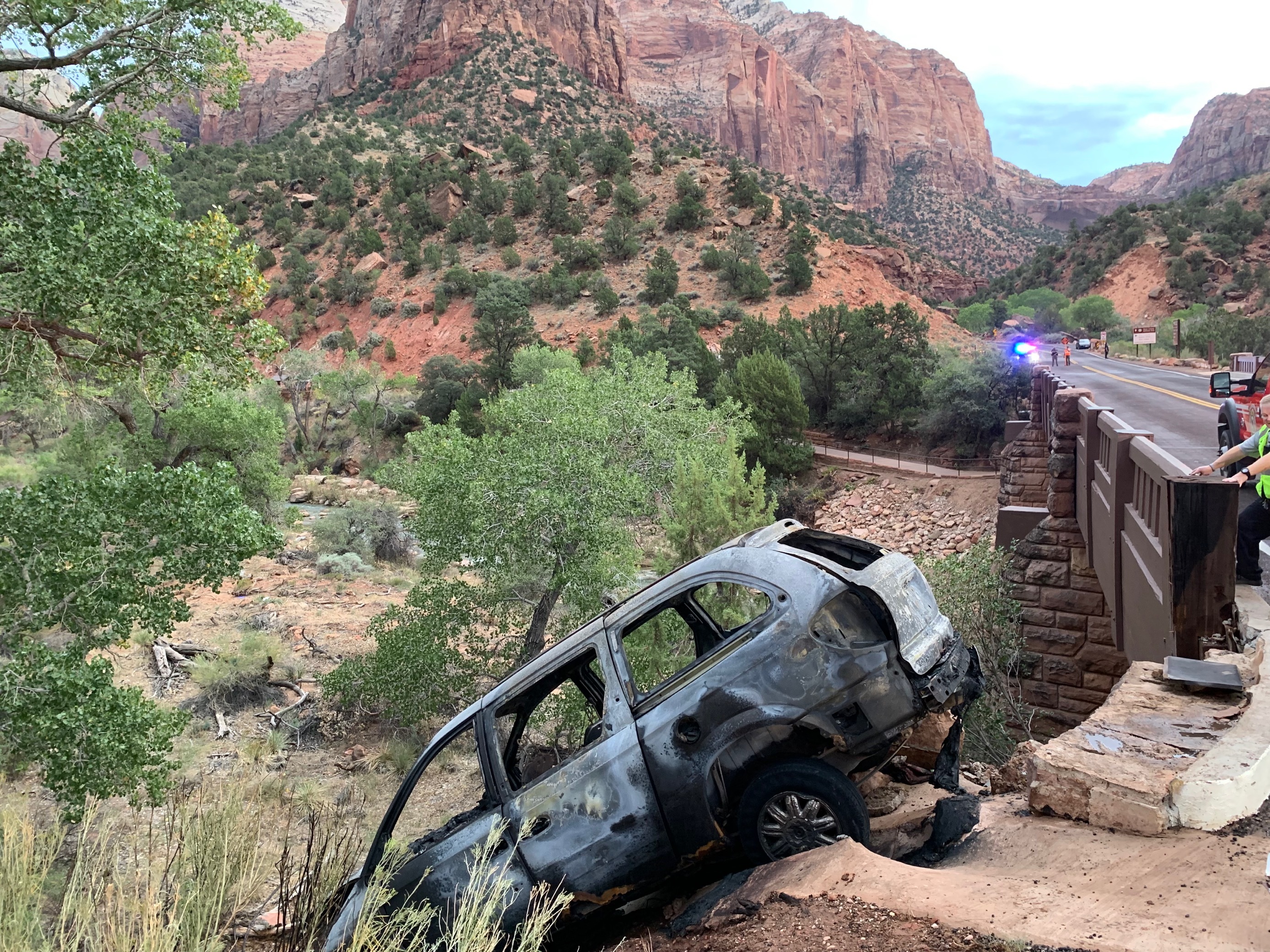 A vehicle crashed at the Canyon Junction bridge and started a small fire on Tuesday. Law enforcement was in pursuit of a person in the car in connection with possible arson in St. George.