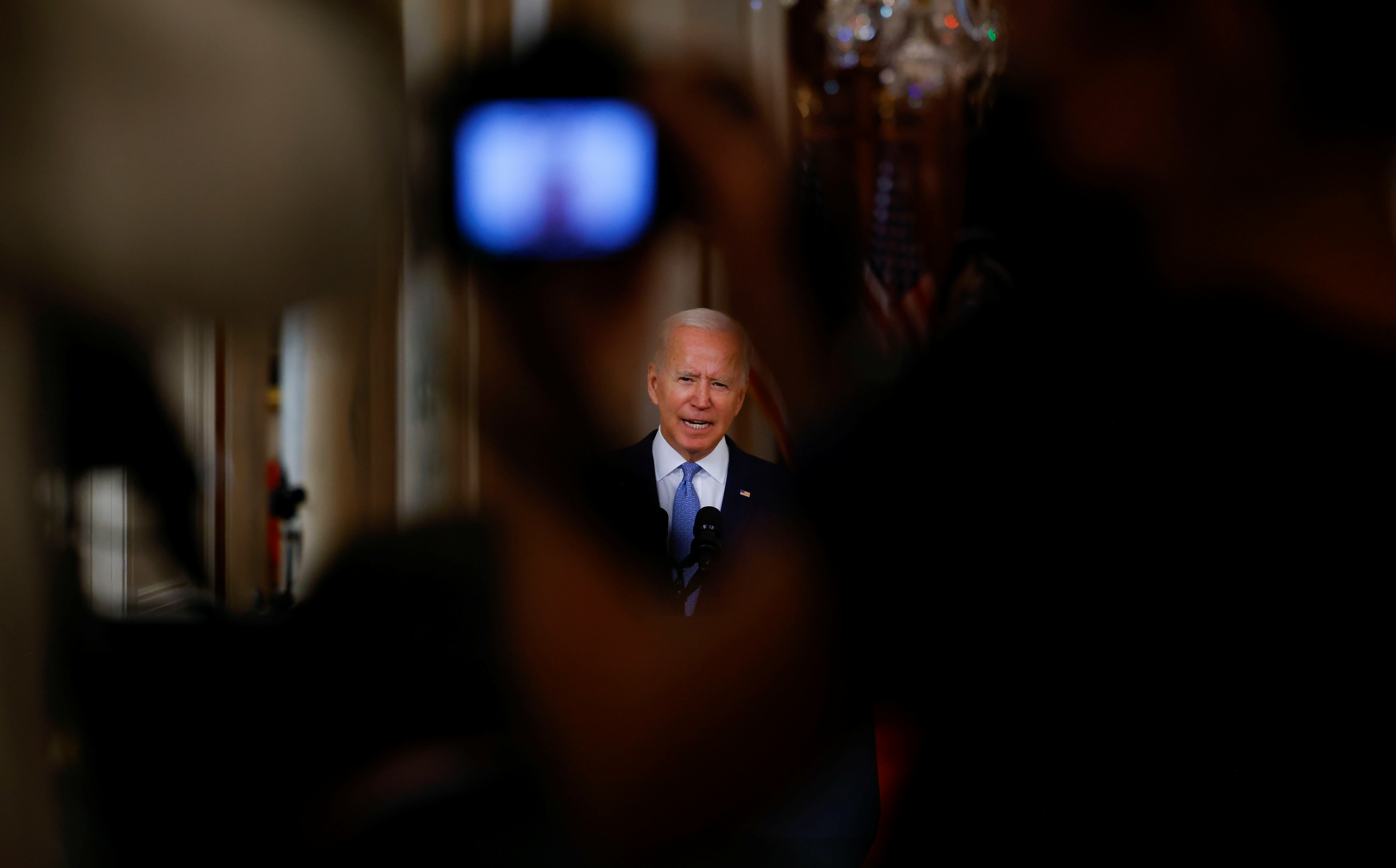 U.S. President Joe Biden is seen in a camera viewfinder as he delivers remarks on Afghanistan during a speech in the State Dining Room at the White House on Tuesday.