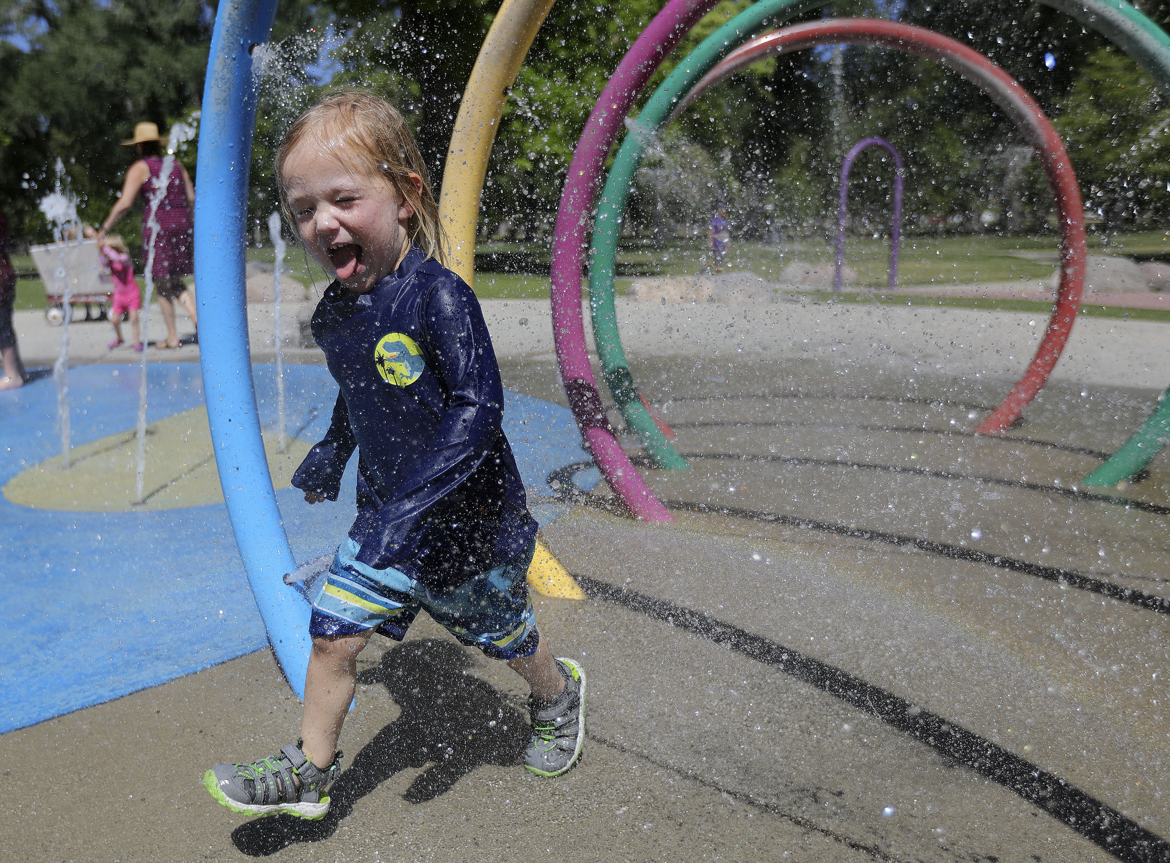 Miles Rosenberg cools off at the splash pad at Liberty Park during a heat wave in Salt Lake City on June 14. This year — 2021 — tied the record for hottest summer in Salt Lake City history, the National Weather Service reported Wednesday.