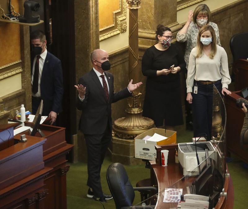 Gov. Spencer Cox, center, throws his hands in the air
as he enters the House chamber after jokingly being introduced as
Gov. Gary Herbert by Rep. Francis Gibson, R-Mapleton, at the end of
the 2021 legislative session in the House chamber at the Capitol in
Salt Lake City on March 5.