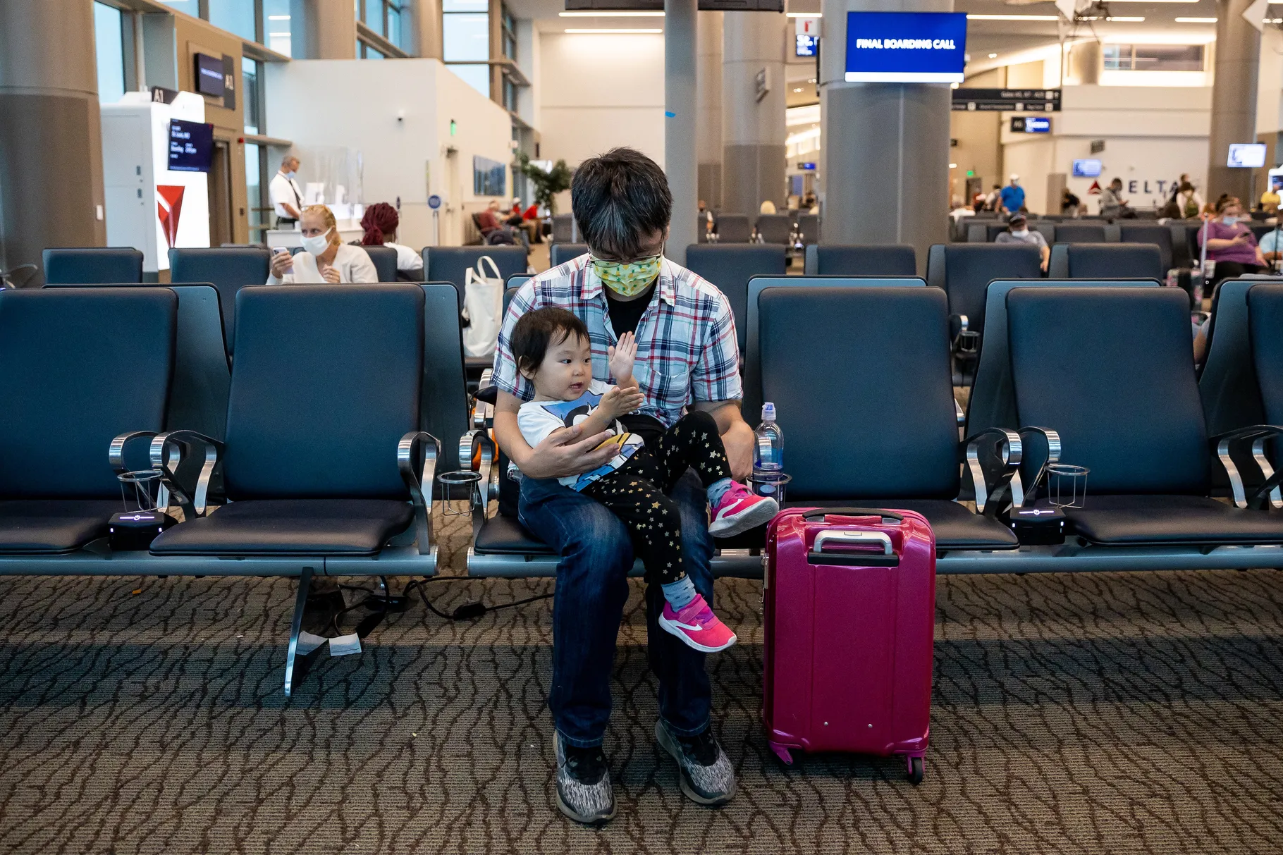 Kazuhide Aikoh plays with his son, Lino, 2, before their flight to San Jose, Calif., at Salt Lake City International Airport in Salt Lake City on Wednesday, Aug. 18. 