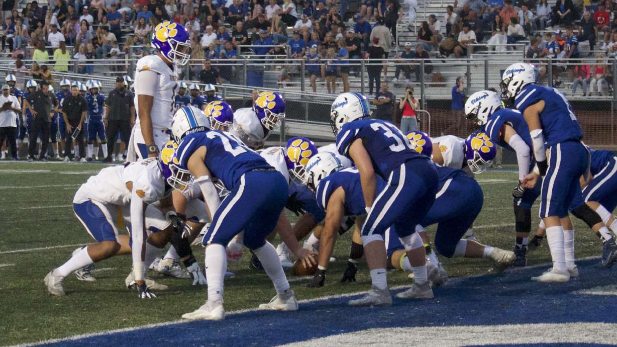 Orem quarterback Chase Tuatagaloa (1) huddles the team during the Tigers' win over the Vikings, Friday, Aug. 27, 2021 in Pleasant Grove.