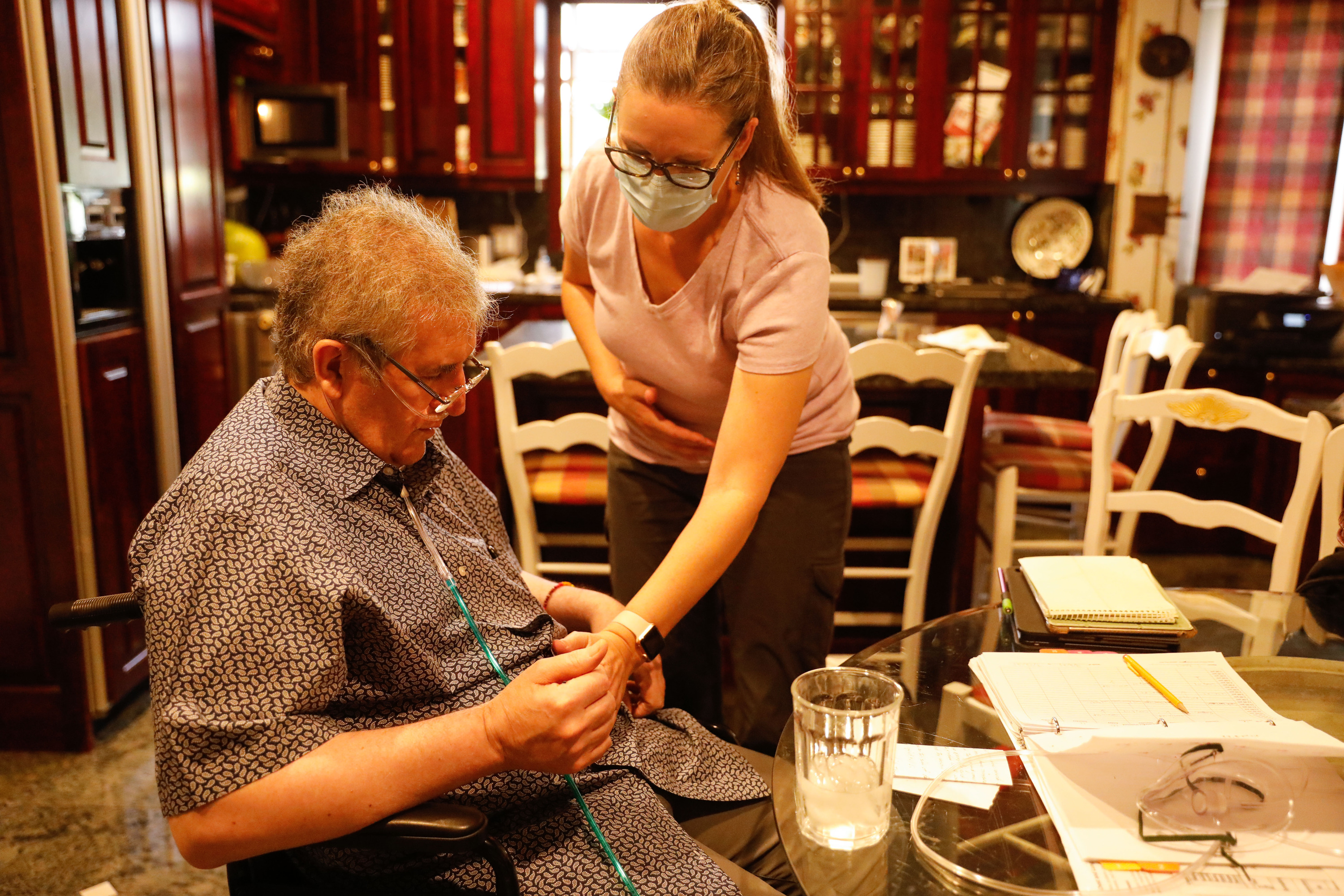 Thomas Kearl participates a therapy session with therapist Jessica Patton at his house in Salt Lake City on Thursday. Kearl, 59, fought to survive COVID-19 in a hospital for 223 days before he was finally able to return home last week.