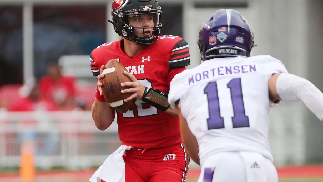 Utah Utes quarterback Charlie Brewer (12) is under pressure from Weber State Wildcats linebacker Conner Mortensen (11) during the season opener at Rice-Eccles Stadium in Salt Lake City on Thursday, Sept. 2, 2021. Weber lead 7-3 at the lightning strike delay.