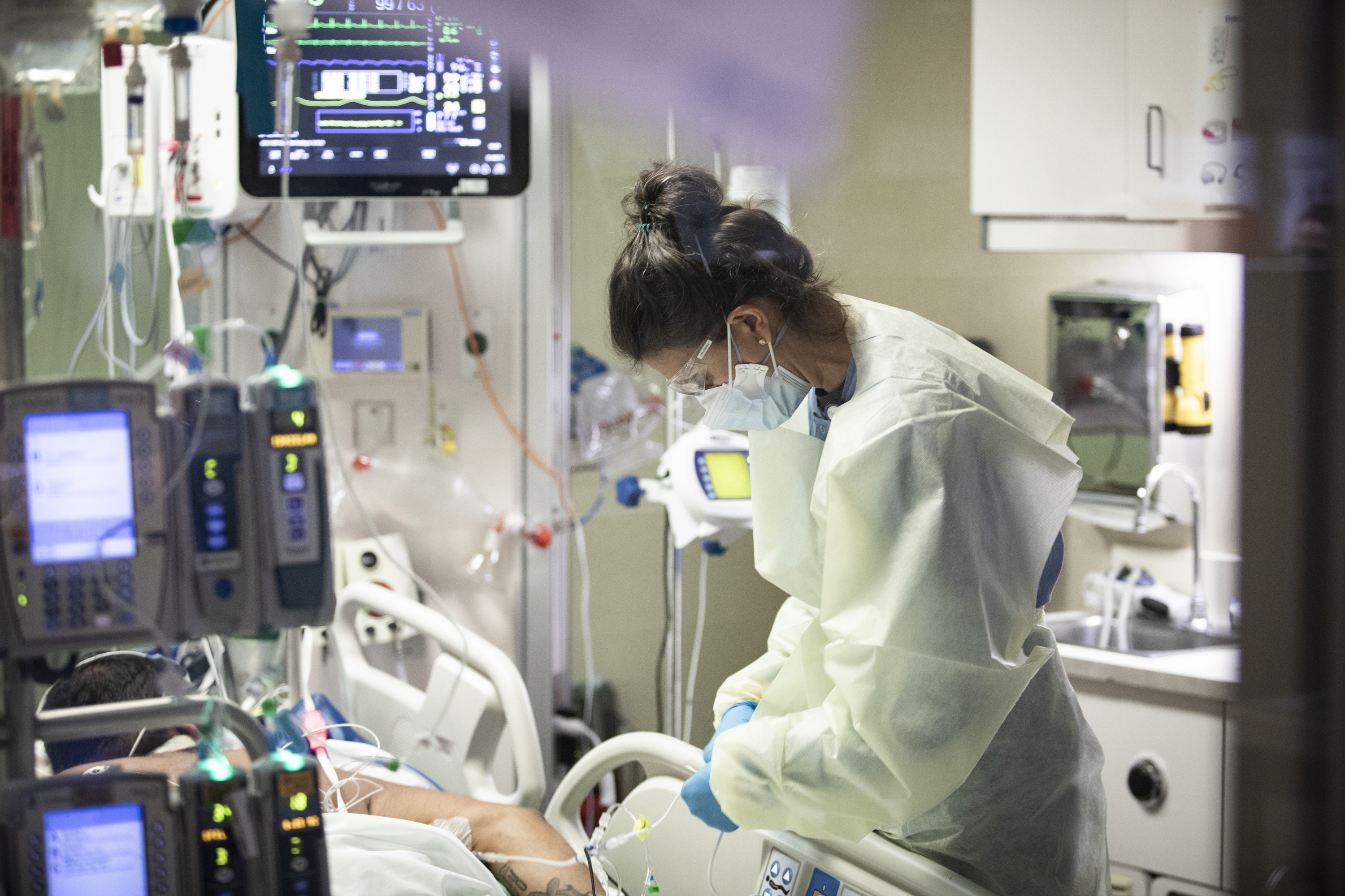 Ann Enderle, R.N., checks on a COVID-19 patient in the medical intensive care unit at St. Luke's Boise Medical Center in Boise, Idaho on Tuesday, Aug. 31. There are only 4 open ICU beds available in all of Idaho as of Tuesday.
