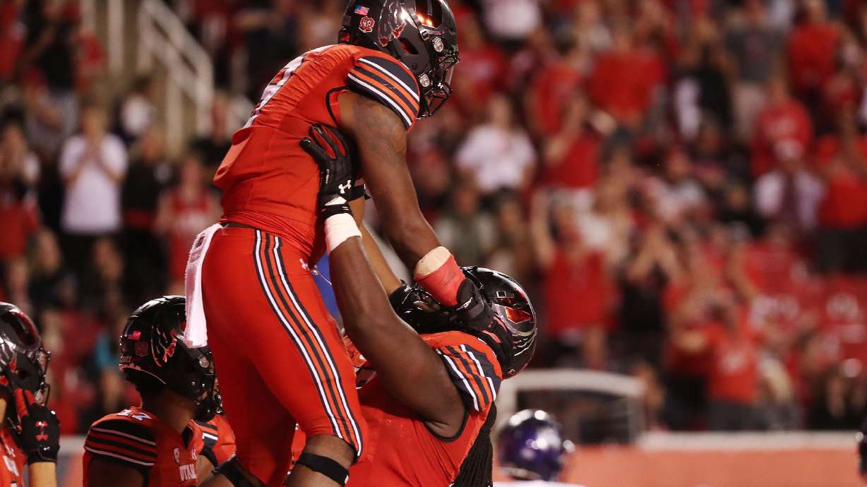 Utah Utes running back Tavion Thomas (9) celebrates his touchdown with Utah Utes offensive lineman Bamidele Olaseni (77) during the season opener at Rice-Eccles Stadium in Salt Lake City on Thursday, Sept. 2, 2021.
