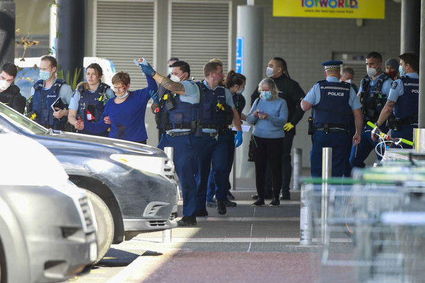 Police and ambulance staff attend a scene outside an Auckland supermarket Friday.