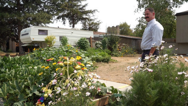 Jason McHann shows off his vegetable garden and water-wise flowers.