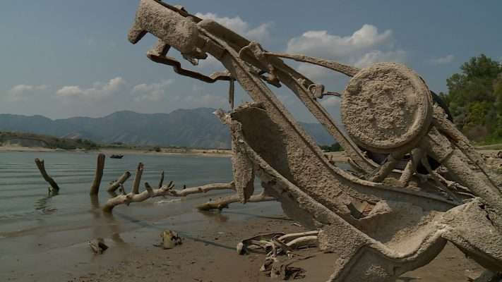 Low water levels have revealed more than a dozen cars that officials said were dumped at Hyrum Reservoir in the 1950s to help strengthen the shoreline.